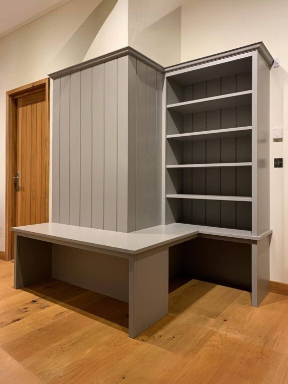 Barn conversion bootroom cabinetry with shoe and coat storage